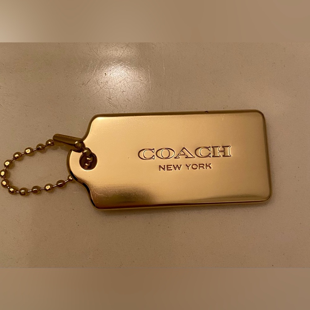 Coach metallic gold tag